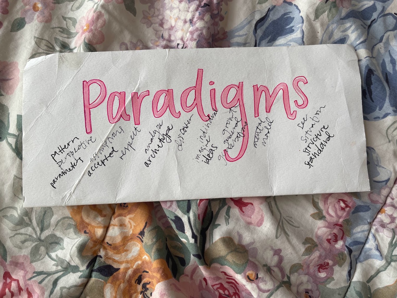 Hand-lettered Paradigms study with handwritten notes on floral fabric