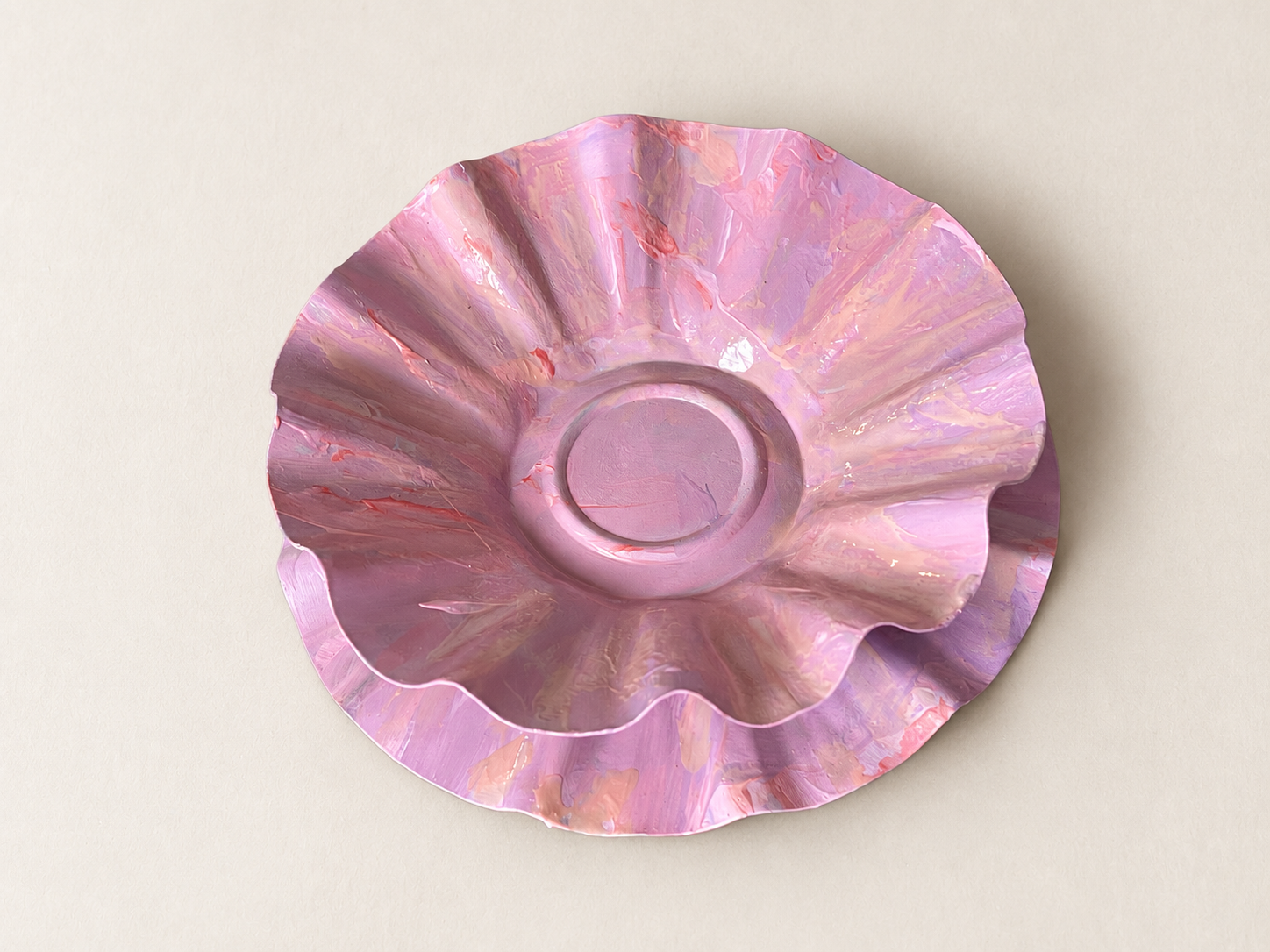 Overhead view of a hand-formed pink aluminum jewelry dish