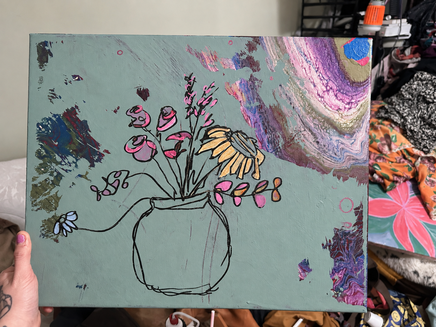 A hand-painted vase of flowers on a layered green canvas